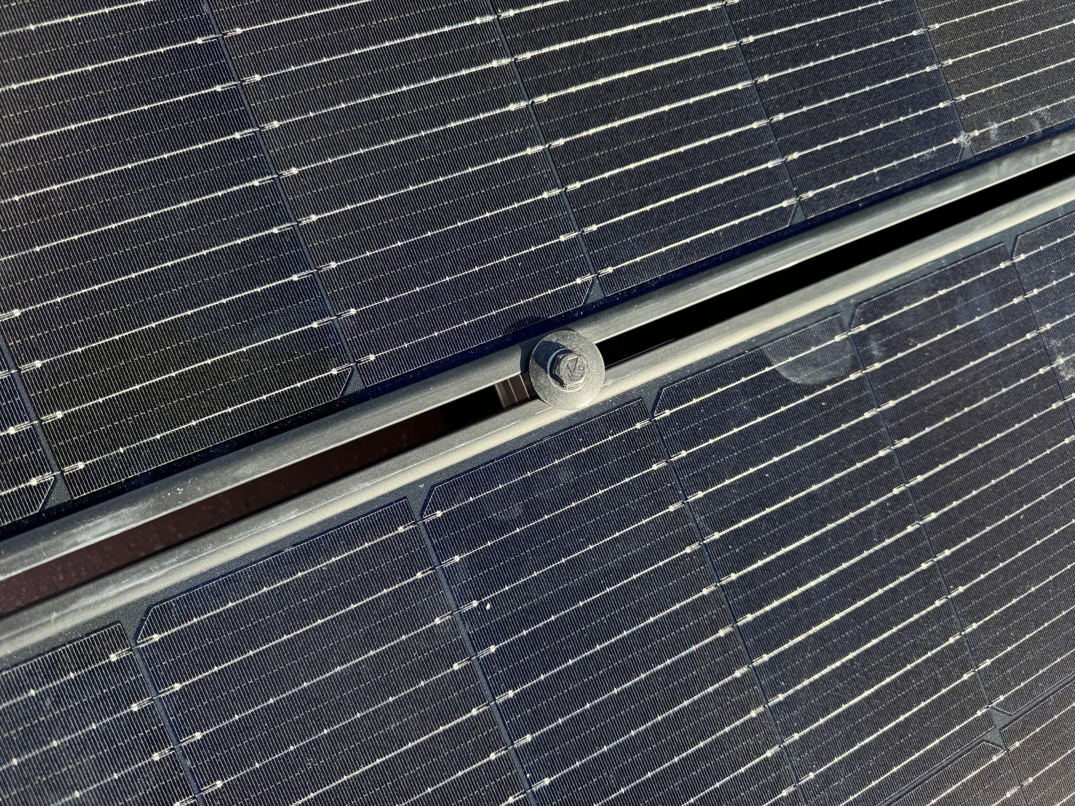 Close-up of solar module glass before cleaning, showing accumulated dust and soiling across the cell surface