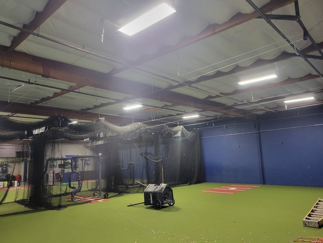 Commercial LED light fixtures mounted overhead in a completed retrofit, replacing older fluorescent lighting