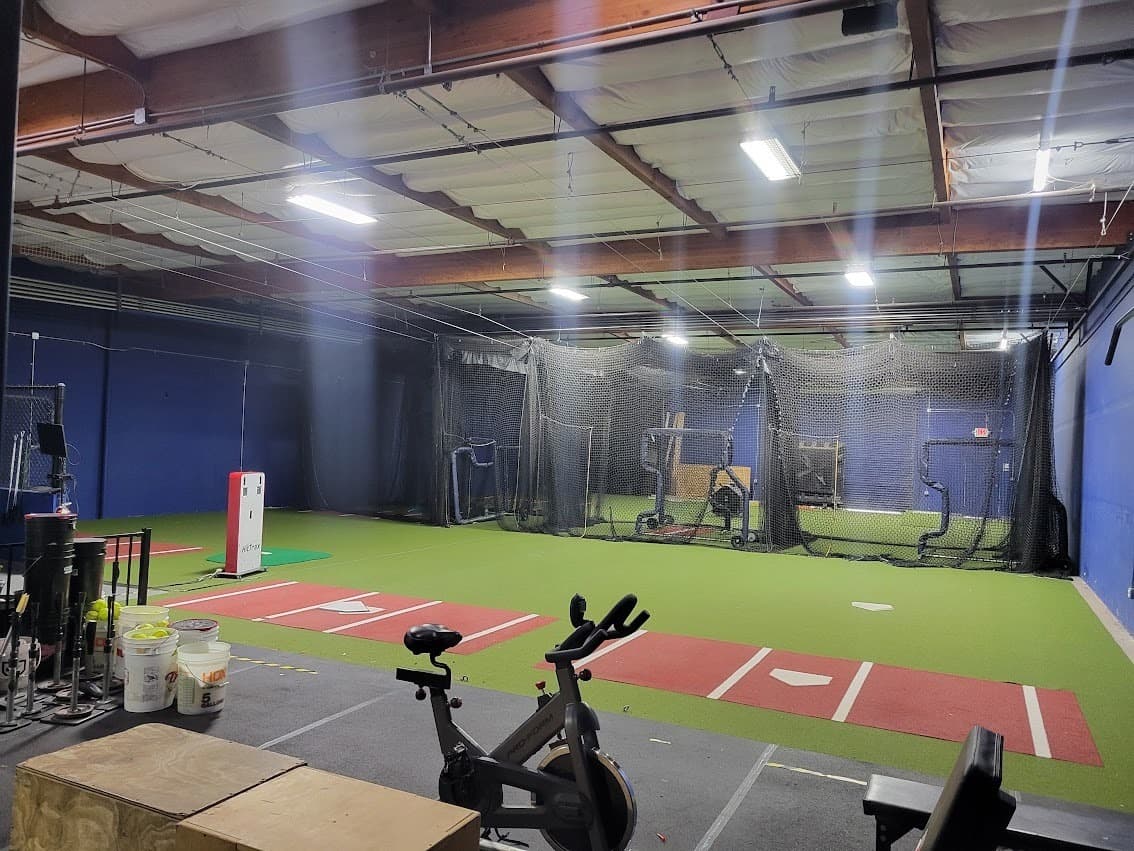 Overhead lighting across an open commercial facility floor after a full retrofit, showing even light coverage between bays